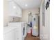 A bright laundry room features a washer, dryer, water heater, and storage at 1489 L R Schronce Ln, Iron Station, NC 28080