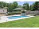 Private in-ground pool in backyard with grass and established landscaping at 1489 L R Schronce Ln, Iron Station, NC 28080