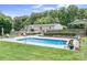 Backyard featuring a refreshing pool, deck, and a well-maintained lawn with lush greenery surrounding the outdoor oasis at 1489 L R Schronce Ln, Iron Station, NC 28080