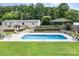 In-ground swimming pool surrounded by manicured landscaping in backyard at 1489 L R Schronce Ln, Iron Station, NC 28080