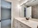 Well-lit bathroom featuring a vanity with a sleek countertop and a view into an adjacent bedroom at 1529 Covenant Pl, Rock Hill, SC 29732