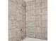 Bathroom tiled with gray square tiles, featuring modern fixtures and a sleek shower head at 1529 Covenant Pl, Rock Hill, SC 29732