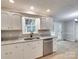 Well-lit kitchen with white cabinets, granite countertops, and stainless steel appliances including a dishwasher at 1529 Covenant Pl, Rock Hill, SC 29732