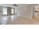 Open living room with hardwood floors, large windows, and view into dining and kitchen areas at 1529 Covenant Pl, Rock Hill, SC 29732
