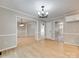 Spacious living room with hardwood floors, chandelier, and neutral paint, providing versatile living space at 1529 Covenant Pl, Rock Hill, SC 29732