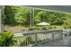Backyard view from the deck showcasing a beautiful lawn, landscaping, and mature trees at 17537 Caddy Ct, Charlotte, NC 28278