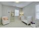 Calm bedroom with a crib, chair, and ladder, creating a peaceful Bedroom at 17537 Caddy Ct, Charlotte, NC 28278