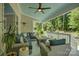 Comfortable covered deck with outdoor seating, a fire table, and views of the private backyard at 17537 Caddy Ct, Charlotte, NC 28278