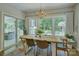 Dining room with large windows overlooking the backyard and stylish chandelier at 17537 Caddy Ct, Charlotte, NC 28278