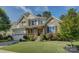 Beautiful two-story home featuring stone accents, an inviting front porch, and lush landscaping at 17537 Caddy Ct, Charlotte, NC 28278