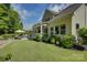 Lovely home exterior showcasing the backyard, patio with dining, and manicured lawn at 17537 Caddy Ct, Charlotte, NC 28278