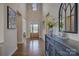 Elegant foyer features hardwood floors, high ceilings, statement lighting and a stylish console table at 17537 Caddy Ct, Charlotte, NC 28278