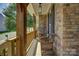 Inviting front porch featuring stone accents and wicker chairs, perfect for relaxing at 17537 Caddy Ct, Charlotte, NC 28278