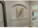 Hallway nook displays unique framed art with an arched alcove, offering a stylish transition space at 17537 Caddy Ct, Charlotte, NC 28278