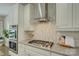Updated kitchen with stainless steel appliances, modern range hood, and stylish backsplash at 17537 Caddy Ct, Charlotte, NC 28278