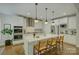 Bright kitchen boasts a large island with seating, stainless steel appliances, and pendant lighting at 17537 Caddy Ct, Charlotte, NC 28278