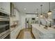 Open kitchen featuring white cabinets, stainless steel appliances, and island with seating at 17537 Caddy Ct, Charlotte, NC 28278