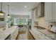 Open kitchen with stainless steel appliances and large windows to the adjacent dining area at 17537 Caddy Ct, Charlotte, NC 28278