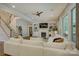 Open living room with fireplace, custom built-ins, a ceiling fan, and staircase at 17537 Caddy Ct, Charlotte, NC 28278