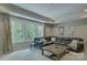 Cozy living room featuring a plush leather sofa, large windows, and a stylish coffee table at 17537 Caddy Ct, Charlotte, NC 28278
