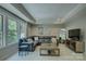 Comfortable living room with large windows, leather sofa and modern décor at 17537 Caddy Ct, Charlotte, NC 28278