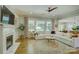 Bright living room features a fireplace, large windows, and a comfortable white sectional sofa at 17537 Caddy Ct, Charlotte, NC 28278