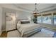 Serene main bedroom with tray ceilings, a chandelier, and natural light from the windows at 17537 Caddy Ct, Charlotte, NC 28278
