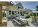 Outdoor dining area featuring a built-in grill and a wooden table with benches on a stone patio at 17537 Caddy Ct, Charlotte, NC 28278