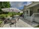 Inviting patio features an umbrella-covered dining set and an outdoor kitchen with a grill at 17537 Caddy Ct, Charlotte, NC 28278