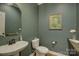 Chic powder room featuring a pedestal sink, modern fixtures, and stylish wall decor at 17537 Caddy Ct, Charlotte, NC 28278