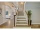 Elegant staircase with wood and white railing, leading to the upper level of the home at 17537 Caddy Ct, Charlotte, NC 28278