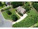 Aerial view of a home with lush landscaping, mature trees, and a long driveway leading to the property at 2019 Heirloom Ct, Matthews, NC 28104