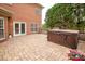Backyard patio features a relaxing hot tub, durable paver flooring, and elegant landscaping, offering a private escape at 2019 Heirloom Ct, Matthews, NC 28104