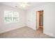 Carpeted bedroom with a large window and an en-suite bathroom entrance at 2019 Heirloom Ct, Matthews, NC 28104