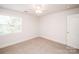 Inviting bedroom featuring a ceiling fan, window, and neutral carpeting at 2019 Heirloom Ct, Matthews, NC 28104