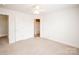 Neutral bedroom featuring a ceiling fan, plush carpet, and two closets at 2019 Heirloom Ct, Matthews, NC 28104