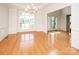 Formal dining room boasts a large window, chandelier, and hardwood floors, perfect for Gathering gatherings and entertaining at 2019 Heirloom Ct, Matthews, NC 28104