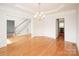 Elegant dining room with hardwood floors, wainscoting, and decorative chandelier at 2019 Heirloom Ct, Matthews, NC 28104