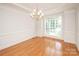 Bright dining room featuring hardwood flooring, wainscoting, and large window at 2019 Heirloom Ct, Matthews, NC 28104
