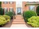 Inviting brick home entrance featuring a glass front door with decorative planters on the steps at 2019 Heirloom Ct, Matthews, NC 28104