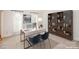 Bright home office featuring a built-in bookcase, large desk, and comfortable seating, ideal for productivity at 2019 Heirloom Ct, Matthews, NC 28104