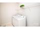 Functional laundry room with appliances and storage shelving at 2019 Heirloom Ct, Matthews, NC 28104