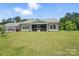 Spacious backyard featuring a well-maintained lawn and a cozy screened-in patio at 231 Cotton Ridge Pl, Rock Hill, SC 29730