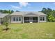 Lush backyard featuring a well-maintained lawn and a cozy screened-in patio at 231 Cotton Ridge Pl, Rock Hill, SC 29730