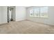 Bright, carpeted bedroom with three windows providing ample natural light at 231 Cotton Ridge Pl, Rock Hill, SC 29730
