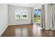 Bright dining area featuring hardwood floors, backyard views, and modern chandelier, with sliding glass door access at 231 Cotton Ridge Pl, Rock Hill, SC 29730