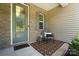 Inviting front porch area with seating, a decorative rug, and stylish glass door at 231 Cotton Ridge Pl, Rock Hill, SC 29730