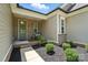 Inviting front porch with manicured landscaping and a glass door, showcasing the entrance to the home at 231 Cotton Ridge Pl, Rock Hill, SC 29730