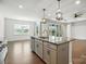 Kitchen island featuring a sink, granite countertop, pendant lighting, and space for dining, connecting to the dining area at 231 Cotton Ridge Pl, Rock Hill, SC 29730