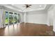 Bright living room with hardwood floors, neutral walls, and sliding glass doors to bring the outdoors in at 231 Cotton Ridge Pl, Rock Hill, SC 29730